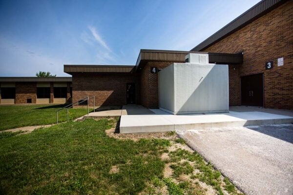 White Polar King walk-in freezer attached to a brick building