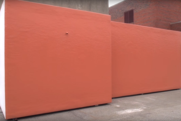 Polar King refrigerated cooler painted orange to match brick exterior