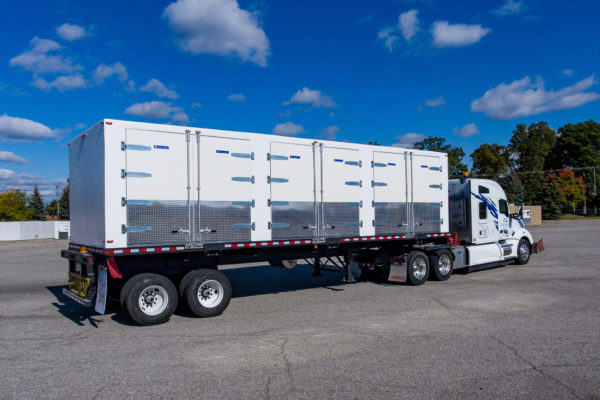 Trailer pulling a large walk-in cooler