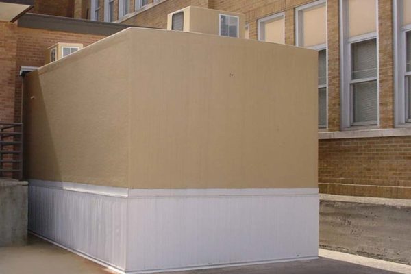 Tan colored refrigeration unit at the back end of McKinney Harrison Elementary