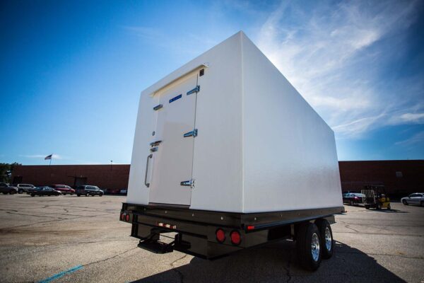 White walk-in freezer cooler trailer outside on concrete